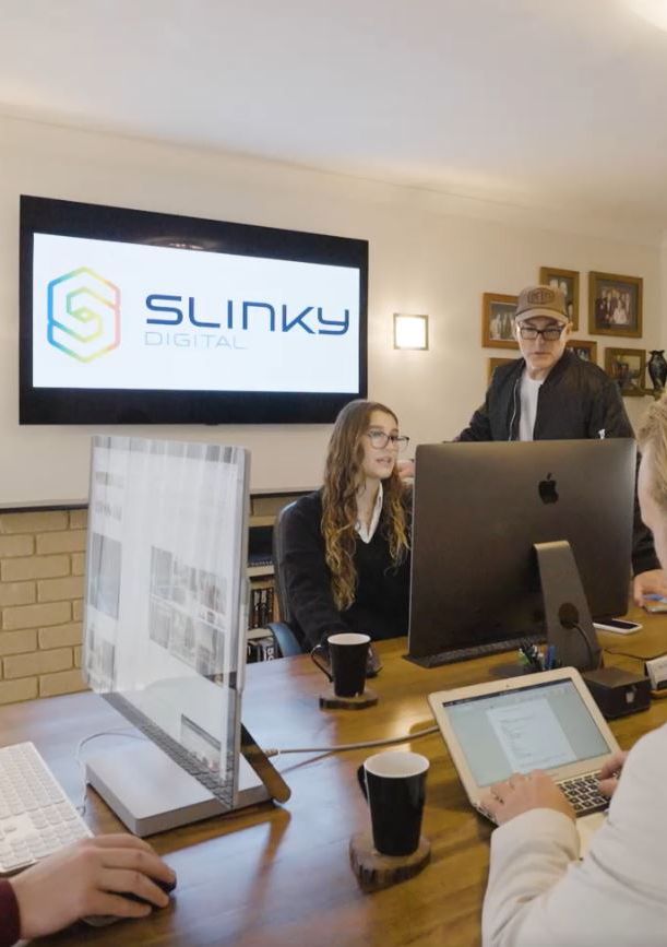 Peter Brittain and the Slinky team in a planning meeting at the Perth office